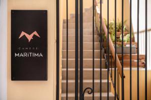 a sign on the door of a building with stairs at Camere Maritima in Chania Town