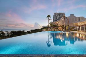 a large swimming pool in front of a resort at The Tsubaki Tower in Tumon