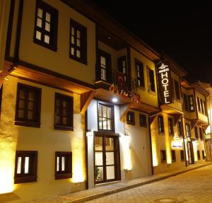 a building with a sign on the side of it at night at Armistis Hotel in Mudanya