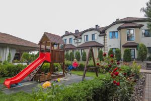 a woman sitting on a swing in a yard at Otte in Myrhorod