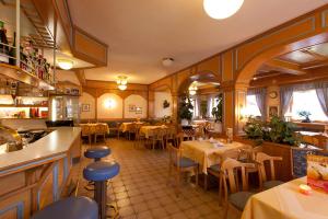 a restaurant with tables and chairs in a room at Holzgauerhof in Holzgau