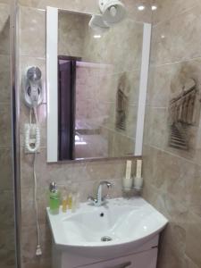 a bathroom with a sink and a shower with a mirror at Park Hotel Manzherok in Manzherok