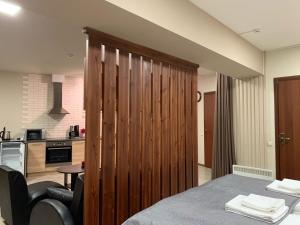 a room with a large wooden partition in a kitchen at Harland apartments in Petrozavodsk