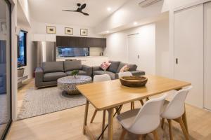 a dining room and living room with a table and chairs at Central Heights - Main Street Views in Margaret River Town