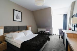 Postel nebo postele na pokoji v ubytování Focus Hotel Premium Elbląg