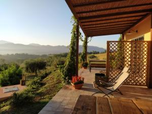 a patio with a bench and a chair on a porch at Le Rapacciole in Spoleto