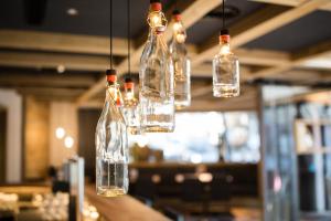 a group of glass bottles hanging from a ceiling at stefan Hotel in Sölden
