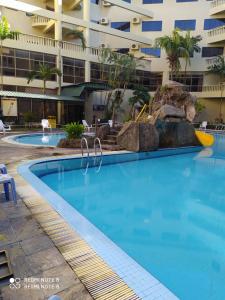 a large swimming pool in front of a building at Pangkor fun fun fun apartment in Pangkor