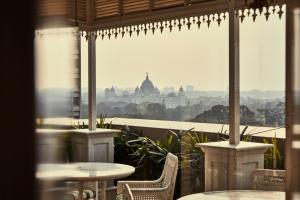 a view of the city from a restaurant with tables and chairs at The Glenburn Penthouse in Kolkata