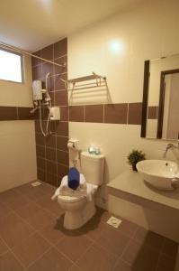 a bathroom with a toilet and a sink at Taman Air Lagoon Resort at A921, unlimited waterpark access, Melaka in Malacca