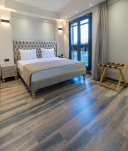 a bedroom with a large bed and wooden floors at Mardia Hotel in Istanbul