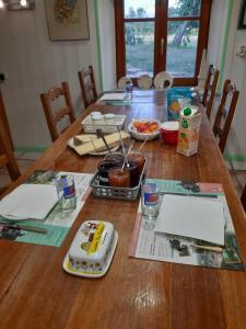 a wooden table with food on top of it at La ferme du bonheur in Pierrefontaine-les-Varans