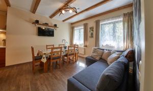a living room with a couch and a table at Appartement Riverside in Saalbach-Hinterglemm