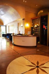 a lobby with a counter in the middle of a room at Hotel Miramare Et De La Ville in Rimini