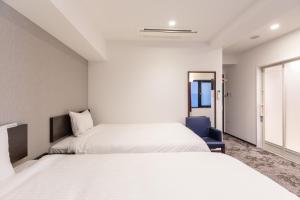 Postel nebo postele na pokoji v ubytování Hotel Tetora Kyoto Station