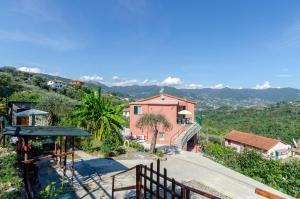 a house on a hill with a view at ALLA CASA ROSA RAPALLO, Peaceful Multiple Apartment Surrounded by Greenery with Free Parking, WiFi & Air Conditioning in Rapallo