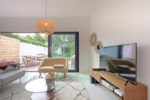 a living room with a large flat screen tv at Fabulous 4 bedrooms villa near Zwin with a garden in Knokke-Heist