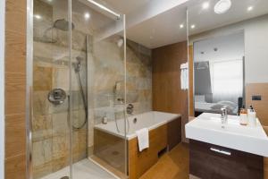 a bathroom with a shower and a sink at Focus Hotel Premium Elbląg in Elblag