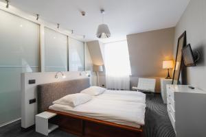 Postel nebo postele na pokoji v ubytování Focus Hotel Premium Elbląg