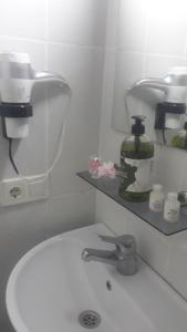 a bathroom sink with a soap dispenser on a shelf at Bachos Hotel sultanahmet in Istanbul