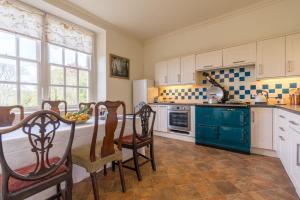 a kitchen with a table and chairs in a room at The Garden House in Dorchester