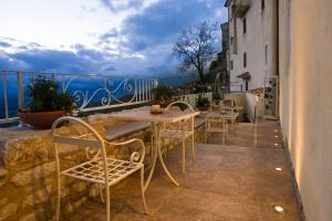 einen Balkon mit Tischen und Stühlen und Meerblick in der Unterkunft Albergo Diffuso Sotto Le Stelle in Picinisco