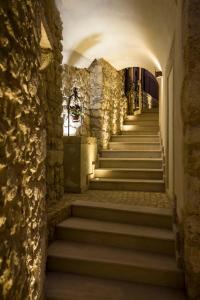a staircase in a building with a stone wall at Albergo Diffuso Sotto Le Stelle in Picinisco