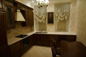 a kitchen with a sink and a stove at Hotel Bolshoy 19 in Saint Petersburg