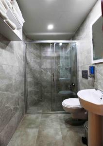 a bathroom with a shower and a toilet and a sink at Sunlight Garden Hotel in Side