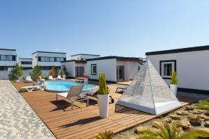 a backyard with a swimming pool and a house at White Villas Koblevo in Koblevo