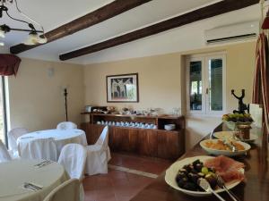 ein Esszimmer mit einem Tisch voller Teller mit Essen in der Unterkunft DIMORA MARELLA Patrica - Frosinone in Patrica