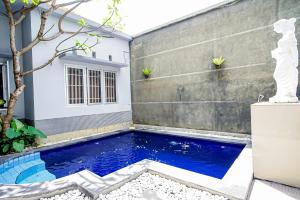 a swimming pool in the backyard of a house at DD Living in Canggu