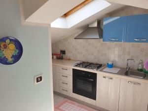 a kitchen with a sink and a stove top oven at Casa Vacanze Umberto I in Bova Marina +21 photos