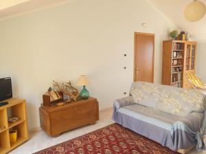 a living room with a couch and a tv at Casa Vacanze Umberto I in Bova Marina