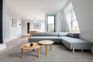 a living room with a couch and a table at Hausd - Leicester Square in London