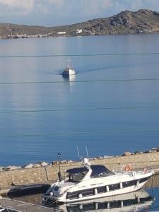 a boat is docked in a body of water at studios FLORA in naoussa paros in Naousa