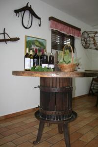 a table with wine bottles on top of a barrel at Camping Jakomin in Koper