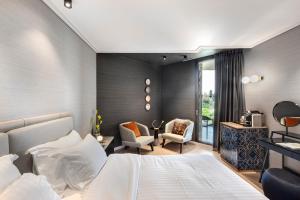 a hotel room with two beds and a table at The Inbal Jerusalem in Jerusalem