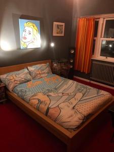 a bedroom with a bed with a painting on the wall at Pop Art Pad heart of Old Town with parking! in Hastings