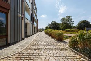a cobblestone sidewalk next to a building at Homewell Boutique Apartments Stare Miasto in Poznań