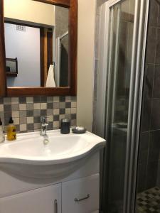 a bathroom with a sink and a shower at Cornerstone B&B Kroonstad in Kroonstad