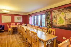 a dining room with a long table and chairs at YHA Dufton in Appleby