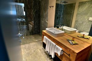 a bathroom with a sink and a mirror at MH Olen Boutique Hotel in Alagna Valsesia +104 photos