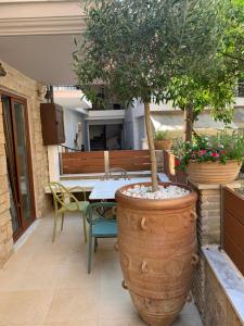 a potted tree in a large pot on a patio at Leda Suites in Parga