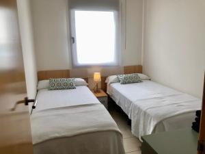 Postel nebo postele na pokoji v ubytování Sun d'Aro