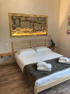 ein Schlafzimmer mit einem großen Bett mit zwei Kissen darauf in der Unterkunft Locanda Il Gallo in Baveno