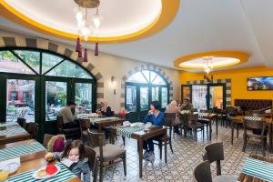 a restaurant with people sitting at tables at Garden House Hotel - Special Class in Istanbul