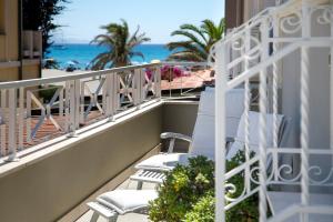 a balcony with chairs and a view of the beach at Hotel La Villa Del Mare in Cagliari