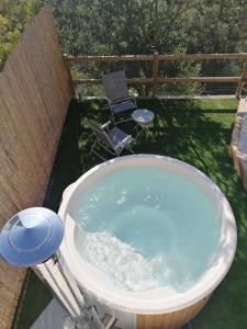 Cal Teixidor - La Fusteria في Salo: حوض استحمام مع كرسي وصحن فريسبي زرقاء