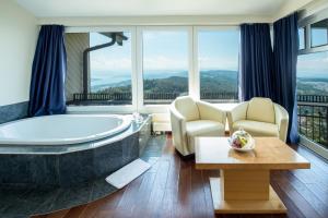 a large bathroom with a tub and a table and chairs at Hotel Uto Kulm - autofrei in Zurich